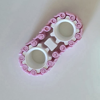 A pink and white plastic track or roller assembly, likely a toy component, photographed on a plain off-white background.