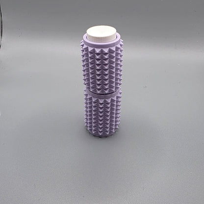 A lavender purple textured cylindrical container with a white screw-on cap, standing upright on a neutral gray background.