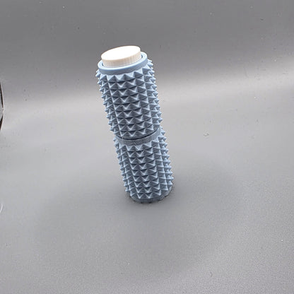 A light blue textured cylindrical container with a white screw cap, standing upright on a gray background.